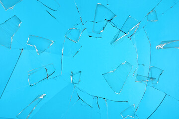 Broken glass with cracks on blue background