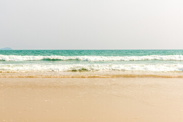 Tropical beach Natural background for summer vacation. Turquoise ocean water and blue sky with clouds in sunny day. Beautiful beach with white sand. 
