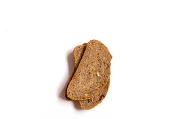 Slices of organic wholemeal bread on a white background and copy space.