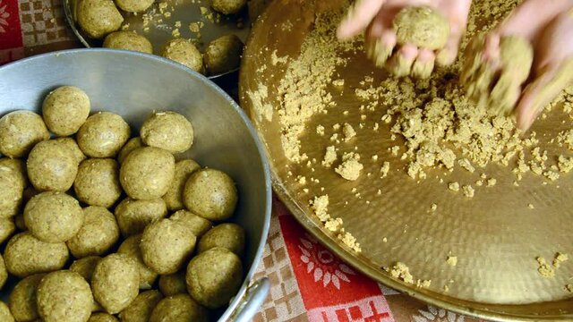 Rural Indian Women Making Laddu of Besan which is Famous sweet dish in India.
