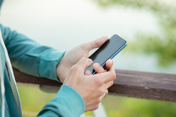 Man using smart phone outdoors