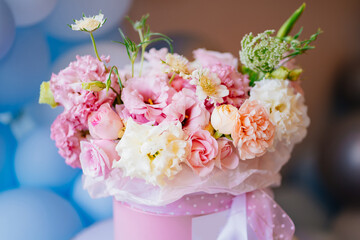 bouquet of delicate white and pink peony roses in a hat box. Floristics. 