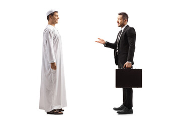 Obraz premium Full length profile shot of a young arab man having a conversation with a businessman with a briefcase