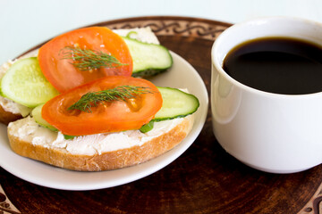 Cup of coffee and vegetable sandwiches. Cucumber, tomato and cream cheese on homemade bread. Traditional breakfast. Vegetarianism concept. Close-up. - 455548097