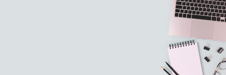 Banner with laptop and stationery on a blue background. Online education, remote work concept with copyspace.