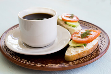 Cup of coffee and vegetable sandwiches. Cucumber, tomato and cream cheese on homemade bread. Traditional breakfast. Vegetarianism concept. Close-up. - 455548294