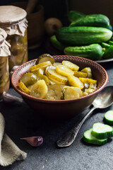 Pickled cucumber salad in a bowl and jars