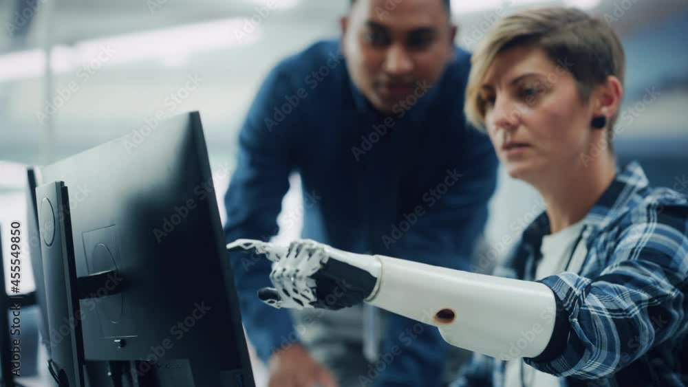 Aufkleber Teamwork In Diverse Office: Smiling Project Manager Talks with Happy Woman with Disability with Prosthetic Arm to Work on Computer. Professionals Create e-Commerce Software App. Rack Focus on Hand
