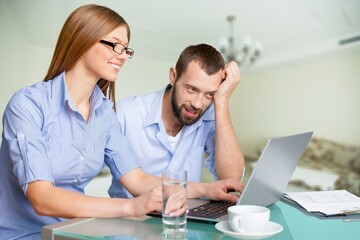 Fototapeta premium Happy confident family couple using app on a computer at home.