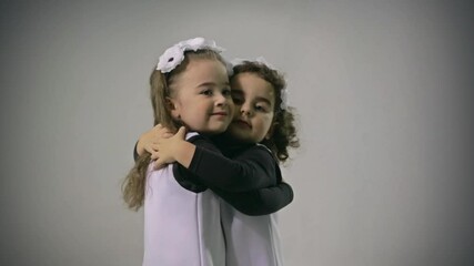 Good looking and loving twins. Little sisters. Smiling, hugging, playing, smiling, dancing, running.  Adorable. Happy lifestyle kids. - Powered by Adobe