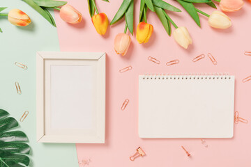 Creative flat lay of travel vacation spring or summer tropical fashion. Top view beach accessories open mockup black notebook for text on pastel background. Top view mock up copy space photography.
