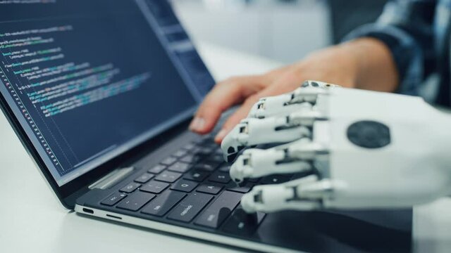Close-up on Hands: Programmer With Disability Using Prosthetic Arm to Work on Computer Keyboard. Specialist Swift and Natural Use of Myoelectric Bionic Hand To Type Code for Software at Night