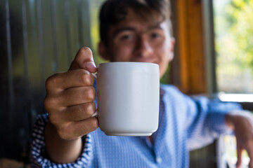 Handsome guy with white cup of tea. Usefull also as template.