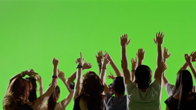 Crowd of fans dancing on green screen. Concert, Jumping, Dancing, Hands up. Slow motion. Shot on RED EPIC Cinema Camera