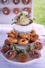 Donuts and cake on stand with flowers