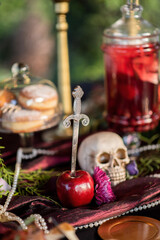 Dagger in apple on table prepared for Halloween