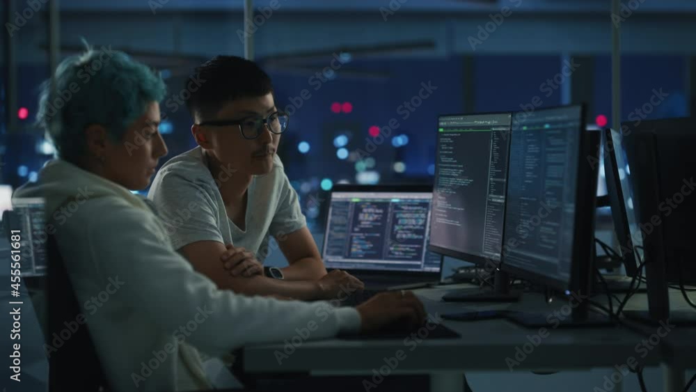 Aufkleber Teamwork In Diverse Office at Night: Project Manager Talks with Creative Solutions Specialist, They Discuss App Code Computer. Stylish Professionals Programming, Create e-Commerce Software