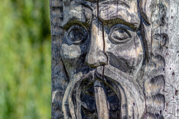 Wooden sculpture of a thoughtful Cossack sage with a mustache and a pipe