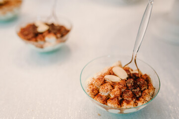 Fototapeta na wymiar Chocolate dessert panna cotta with almond, nuts in glass plate on white background. Coffee choco milk pudding.