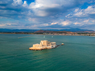Aerial view over Bourtzi, Venetian water fortress at the entrance of the harbour in Nafplio seaside city in Argolis, Peloponnese, Greece.