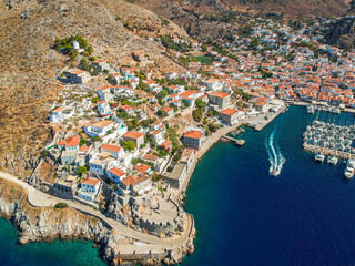 Aerial drone panoramic photo of the picturesque port and main village of Hydra (or Ydra) island at sunset. Hydra is a top tourist destination with neoclassic houses located in Saronic gulf, Greece.