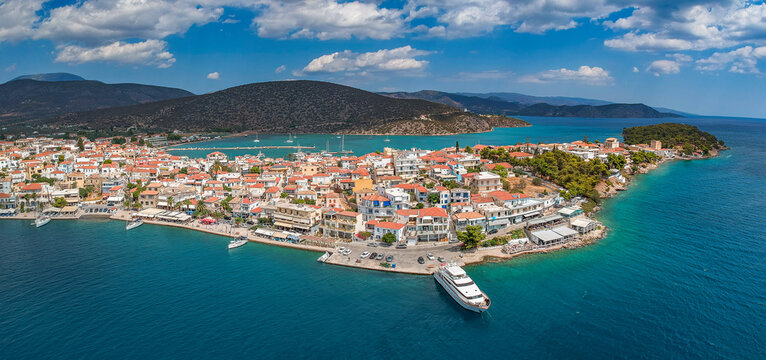 Aerial panoramic photo of picturesque seaside town of Ermioni built in peninsula with forest of Bistis at the end, Argolida, Peloponnese, Greece