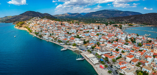 Aerial panoramic photo of picturesque seaside town of Ermioni built in peninsula with forest of Bistis at the end, Argolida, Peloponnese, Greece