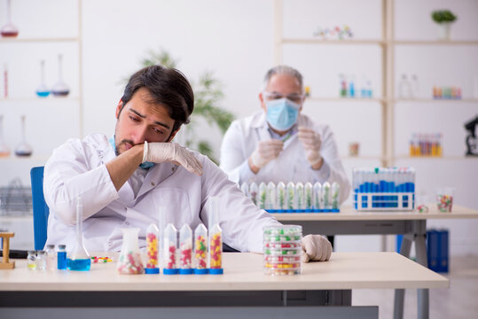 Two male chemists in drugs synthesis concept at the lab