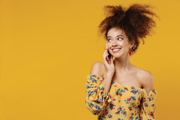 Young happy smiling fun woman 20s with culry hair wear casual clothes talk speak on mobile cell...