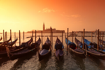 Gondolas in St. Mark's square with Saint George's island at sunrise, Venice, Italy