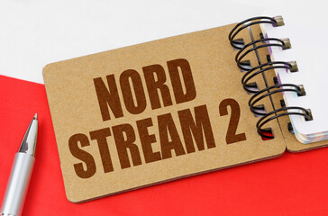 On the flag of Poland lies a notebook with the inscription - Nord Stream 2