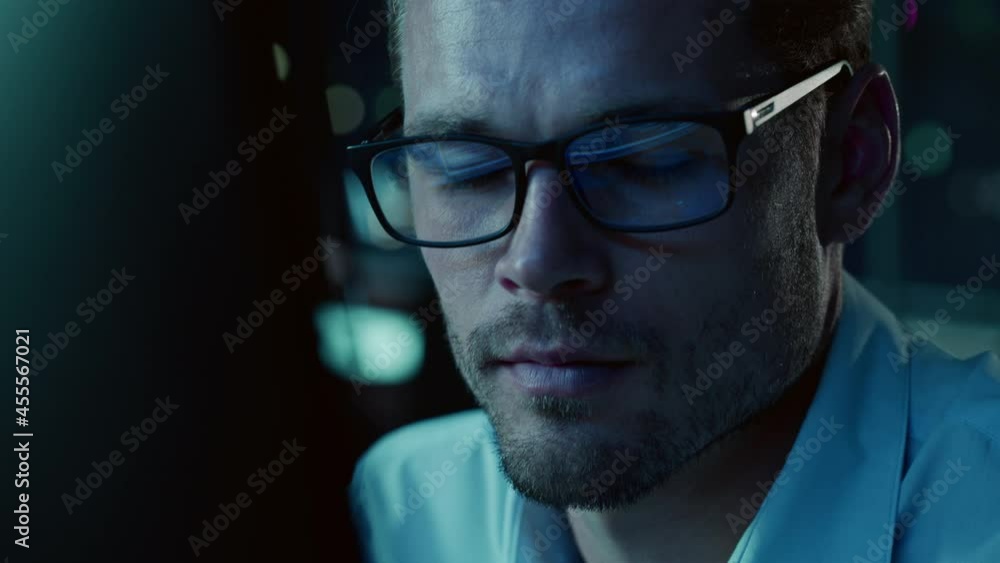 Poster At Night Portrait of Handsome Startup Digital Entrepreneur Working on Computer, Line of Code Reflecting in Glasses. Developer Working on Innovative e-Commerce App using AI Algorithm Big Data. Blue