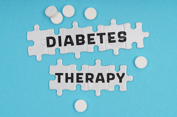 Fototapeta premium On a blue background pills and puzzles with the inscription - DIABETES THERAPY