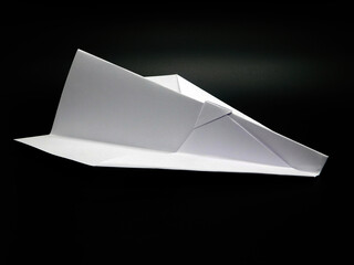 White paper Made Airplane on Black Background