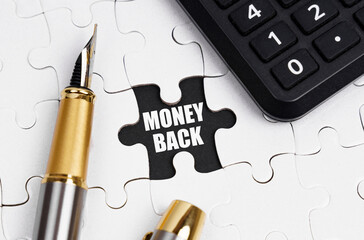 On white puzzles there is a calculator and a pen, in an open cell there is an inscription - MONEY...