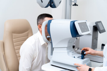 Professional medical equipment scanning patient glasses. Modern clinic healthcare device. Vision...