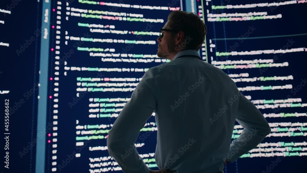 Poster Innovative Startup Concept: Thoughtful Software Engineer Finding Solution, Planning Strategy, Standing and Doing Data Analysis on Big Wall Screen. Programmer Developing e-Commerce App. Back View