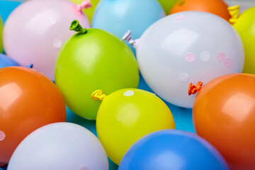 Colorful celebration fun balloons on blue background.
