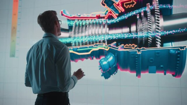 Innovative Green Energy Startup: Engineer Designing Engine Using Tablet Computer and Big Wall Screen to Analyse Prototype. Concept for Sustainable Environmnetally Friendly Carbon Neutral Turbine