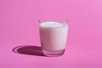 World Milk Day. Pattern on a pink background. A glass of milk. Sample.
