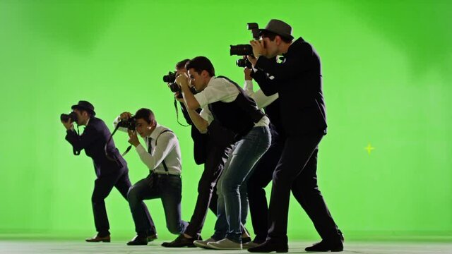 Group of paparazzi or journalists on green screen . Group of photographers photo shooting on green screen. Slow motion. Shot on RED EPIC Cinema Camera.