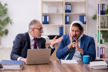 Young male employee suffering from toothache in the office