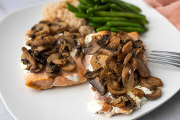 Salmon dinner with brown rice and green beans, topped with plain Greek yogurt and mushrooms.