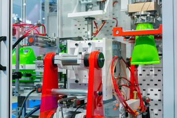 Manufacturing of empty green plastic jerrycans at factory, exhibition - automatic blow molding...