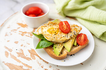 Avocado toast breakfast with fried egg, top view.