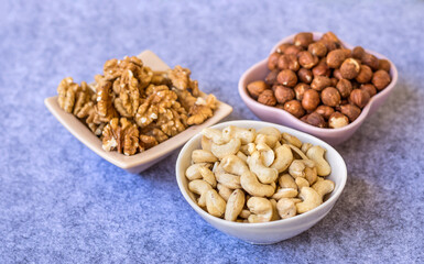 Hazelnuts, Almonds and Cashew   Nuts in Small Ceramic Bowls