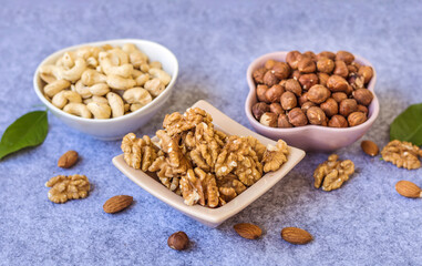 Hazelnuts, Almonds and Cashew   Nuts in Small Ceramic Bowls