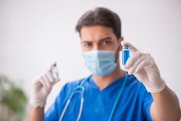 Young male doctor in vaccination concept during pandemic