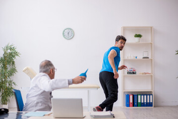 Young male patient visiting old male doctor gastroenterologist