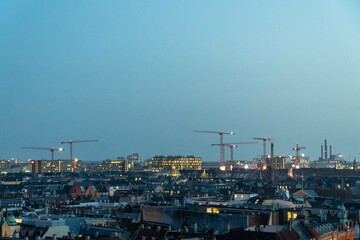 Fototapeta na wymiar Construction cranes and city landscape. Denmark, Copenhagen.